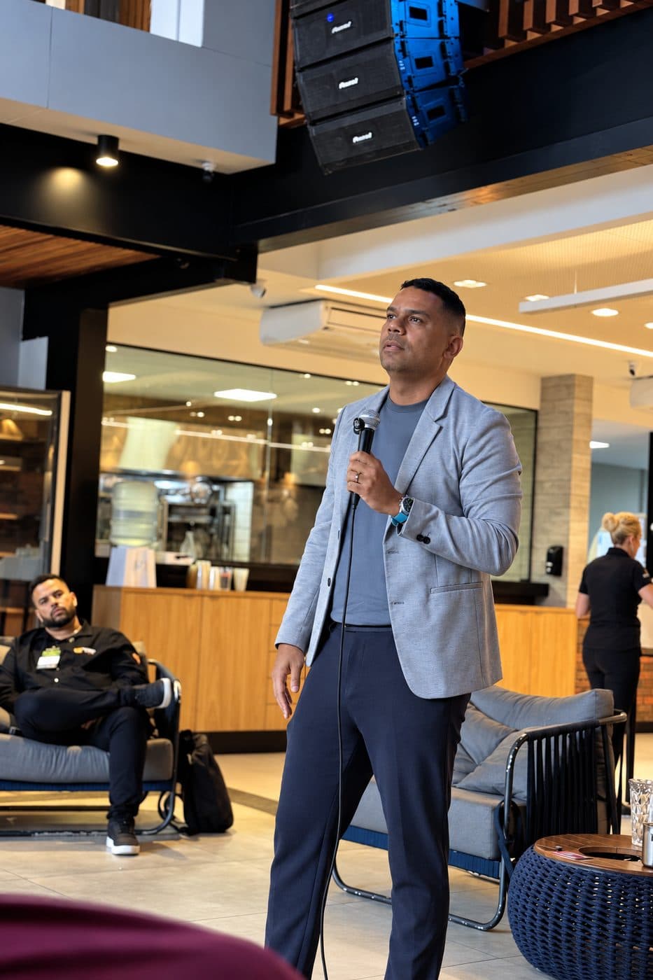 Rafael falando ao microfone em evento corporativo